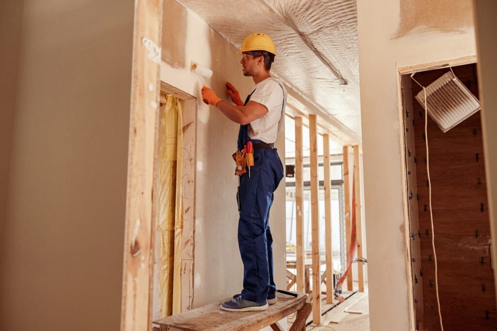 male-builder-painting-wall-in-house-under-construction-1024x682